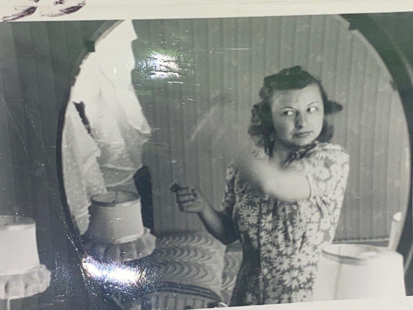 Vintage snapshot photo woman in mirror combing hair black & white 1930s artistic shot