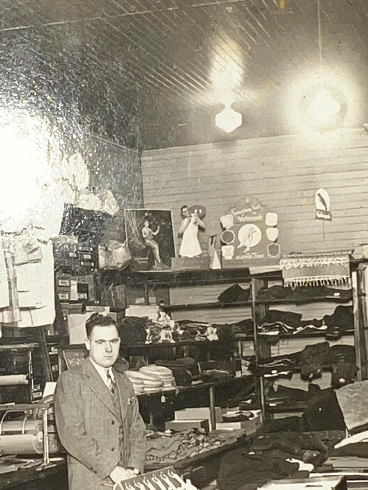 Antique photo Mounted occupational C 1910-1920s Clothing store , heavy plaid hunting jackets hanging, shirts, ties