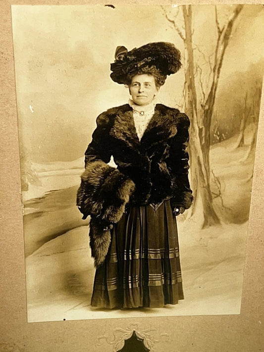 Antique mounted photo woman in fur studio winter scene idd 1900s