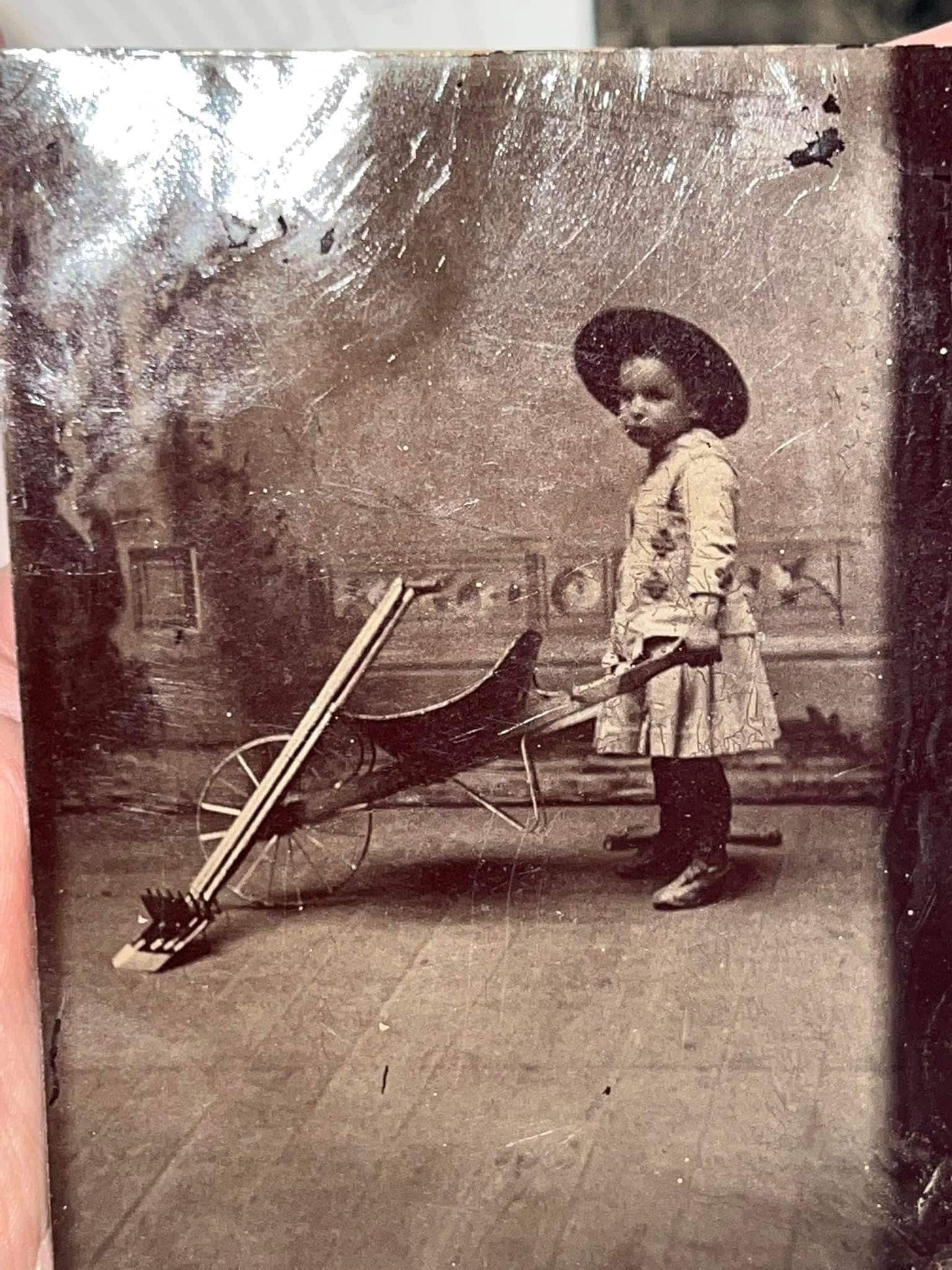 Antique Victorian Tintype Little girl or boy posed with wheel barrow & gardening tools