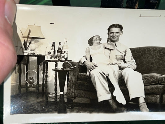 Vintage snapshot photo mid century 1950s military man on couch cardboard cutout woman on lap comical